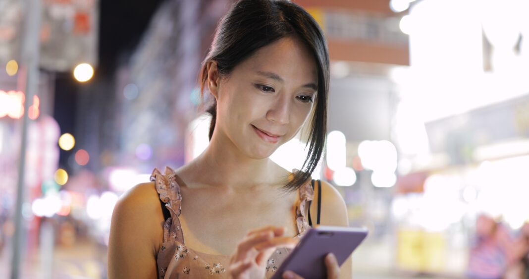 Woman Use Of Smart Phone In City At Night